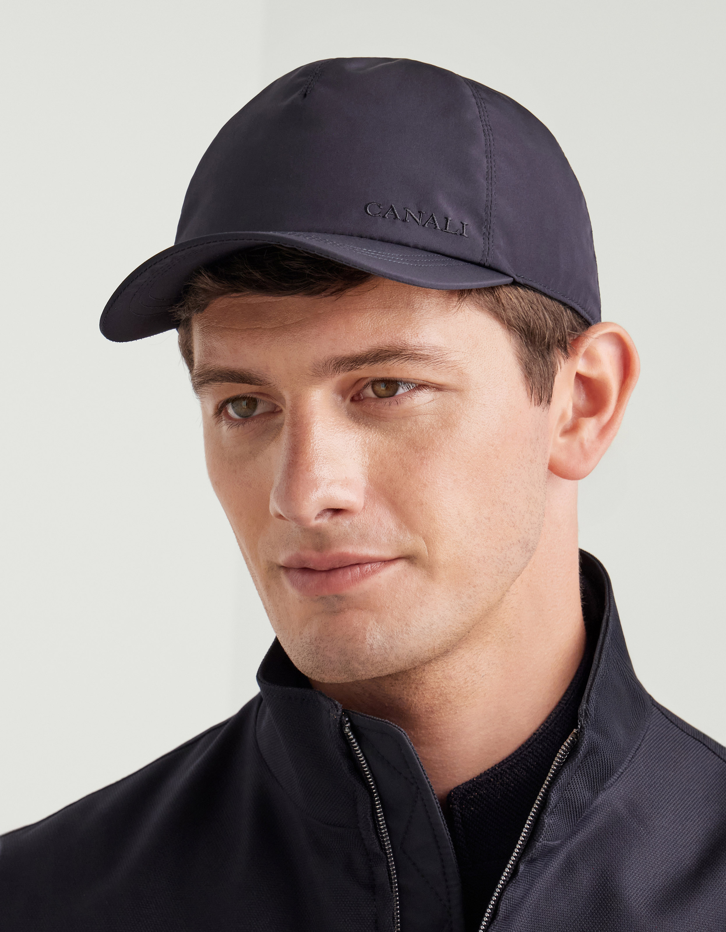 Blue baseball cap with embroidered logo and adjustable leather closure